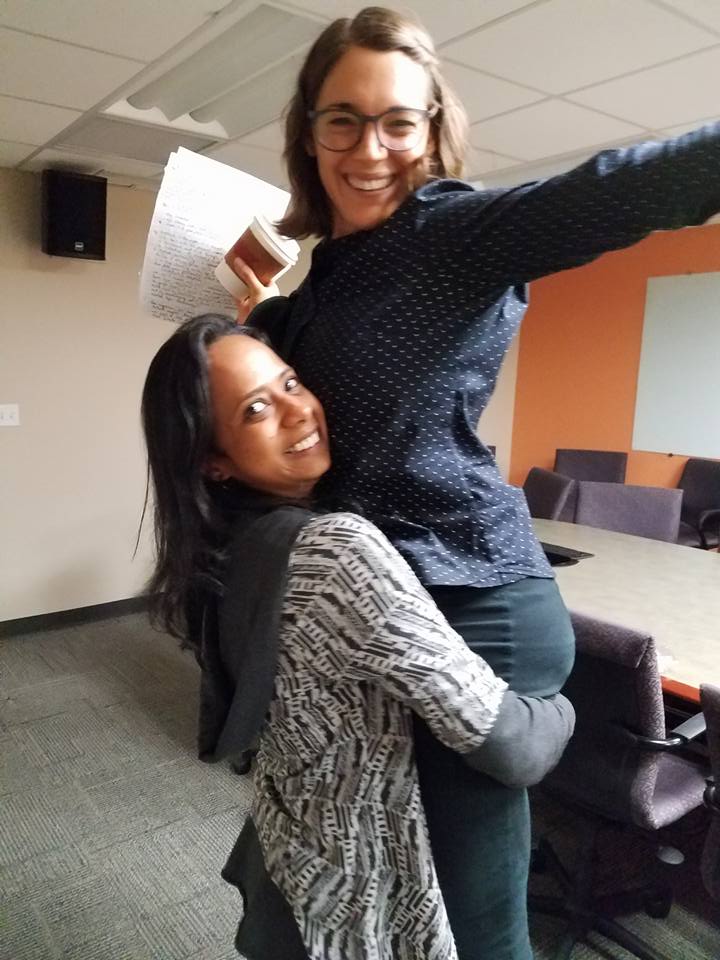 Caitlin McClune's friend Shalmali lifts her up at the end of her successful dissertation defense.
