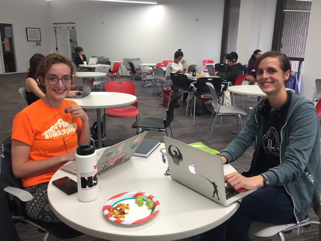 Two students sit together writing during a Writing Retreat.